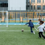 Kids enjoying a soccer game on a school field, showcasing teamwork and sportsmanship.
